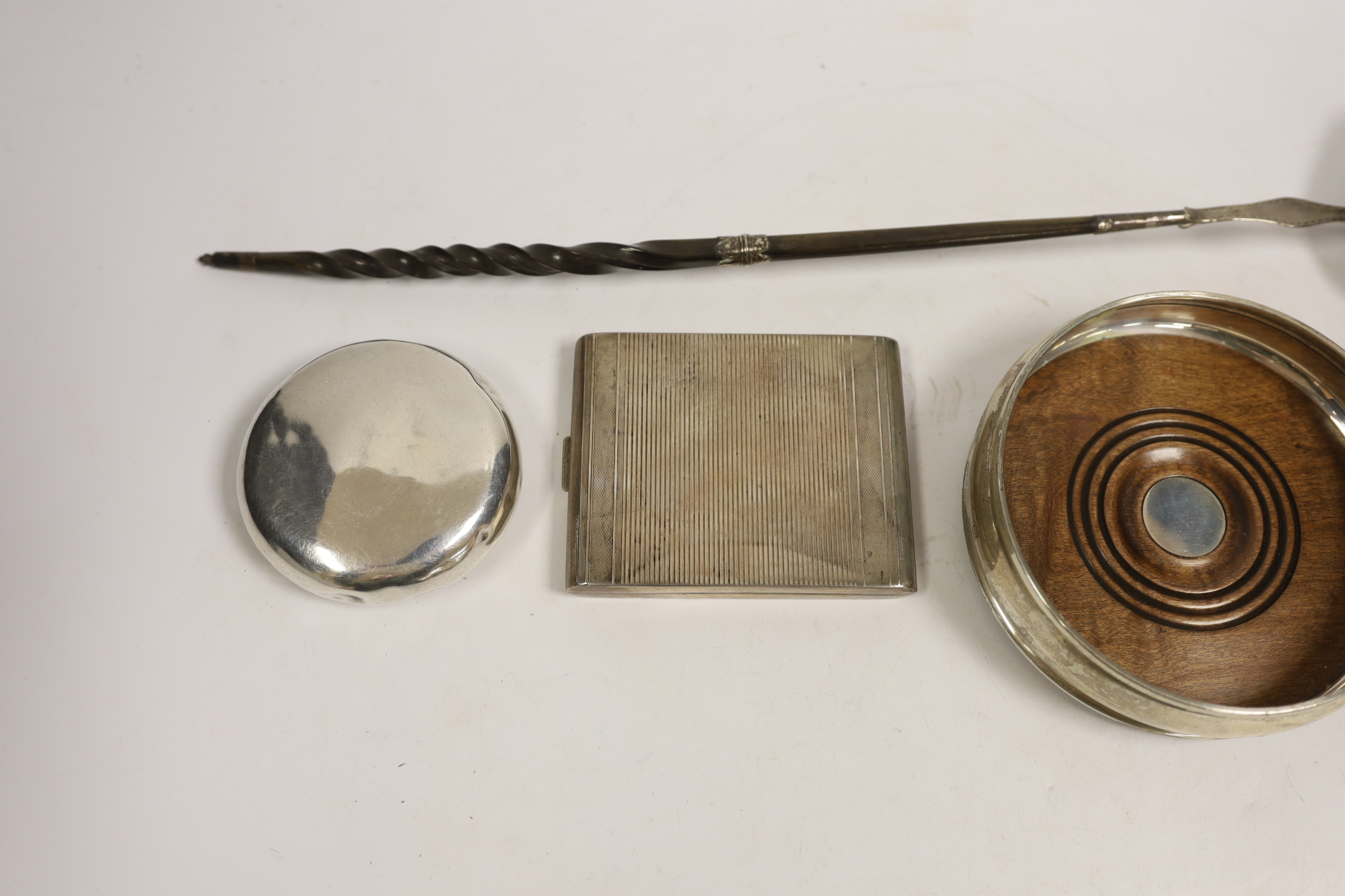 A modern silver mounted wine coaster, a silver sifter spoon, sterling cigarette case, silver tobacco box and a white metal toddy ladle with baleen handle.